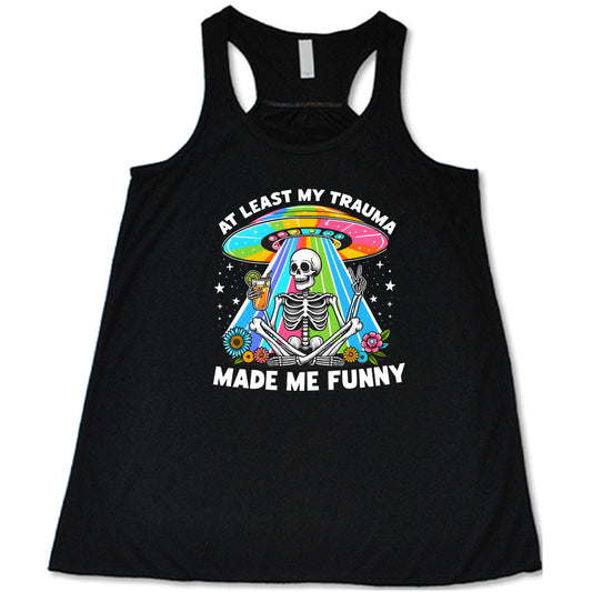 black shirt with the text "At Least My Trauma Made Me Funny" on it