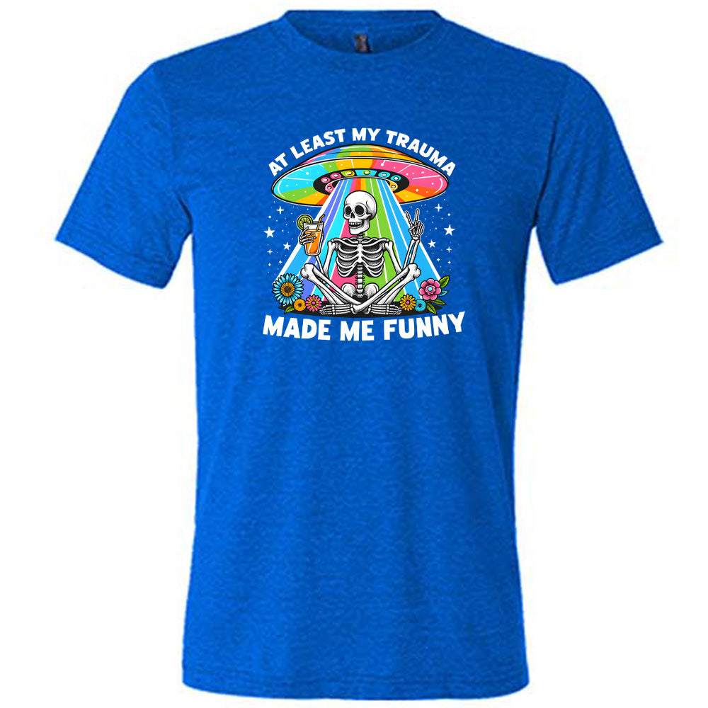 blue shirt with the text "At Least My Trauma Made Me Funny" on it