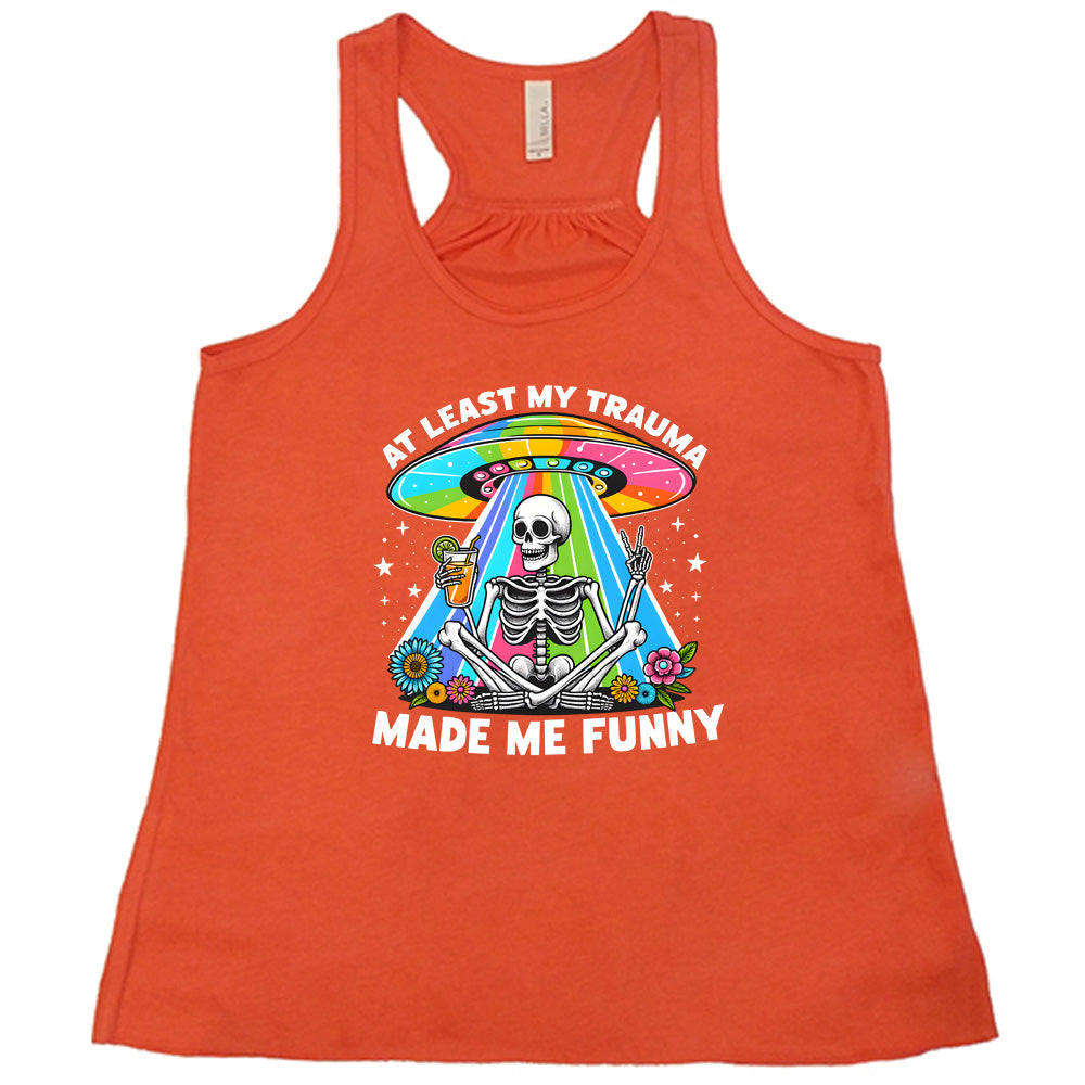 coral shirt with the text "At Least My Trauma Made Me Funny" on it