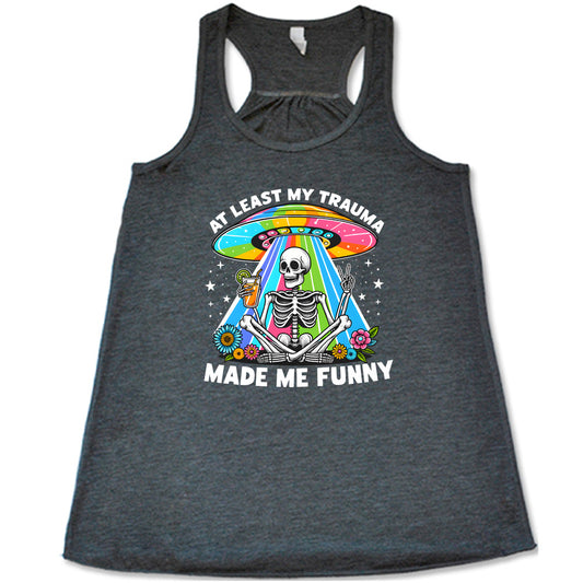 grey shirt with the text "At Least My Trauma Made Me Funny" on it