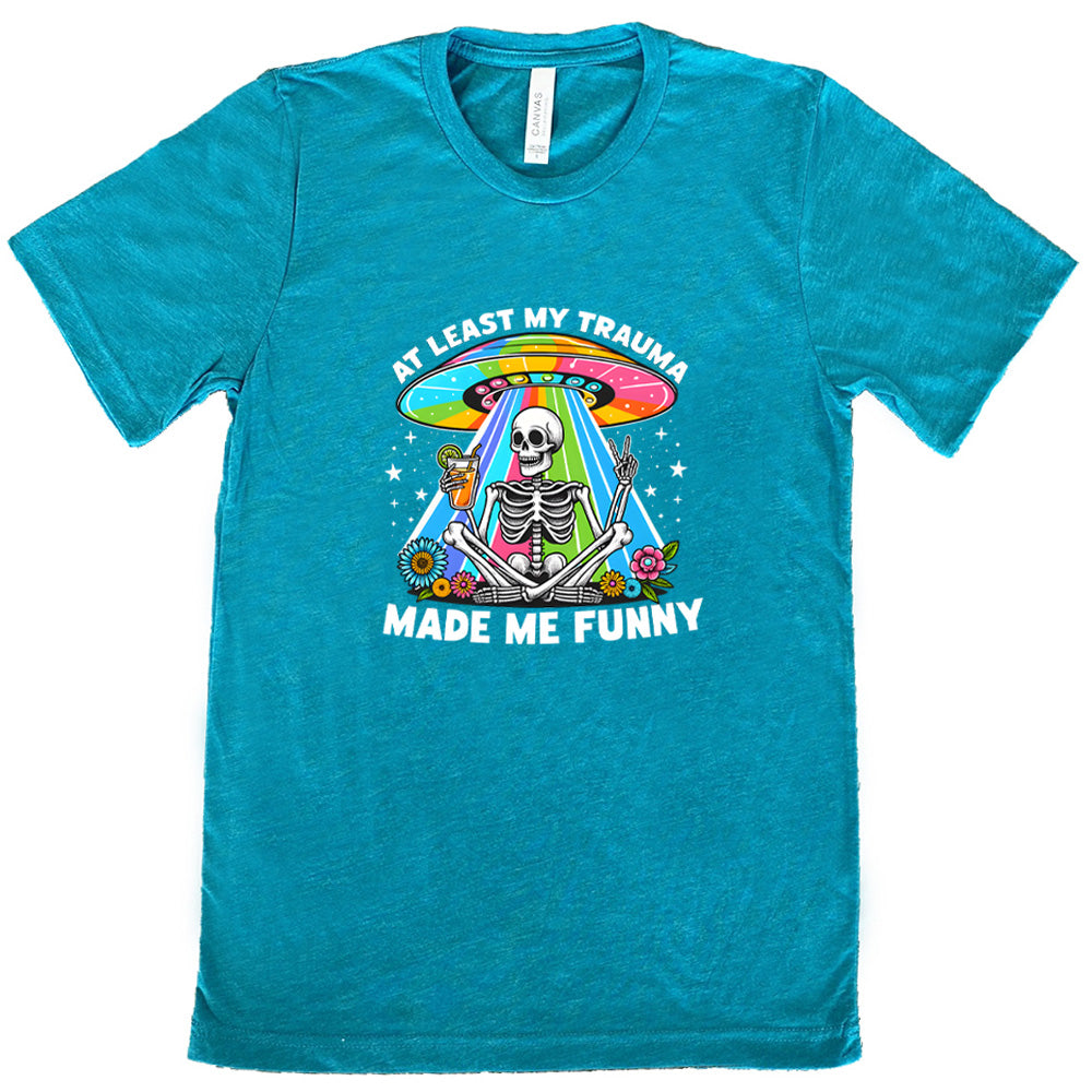 teal shirt with the text "At Least My Trauma Made Me Funny" on it