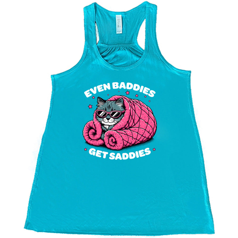 teal shirt with a cat graphic and the text "Even Baddies Get Saddies" on it