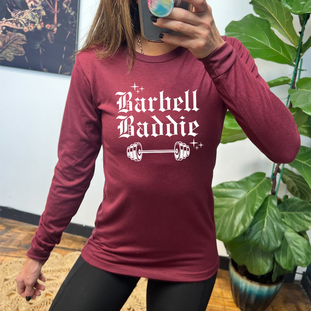 maroon long sleeve with the text "Barbell Baddie" on it