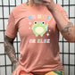 peach shirt with the text "Be Nice Or Else" on it