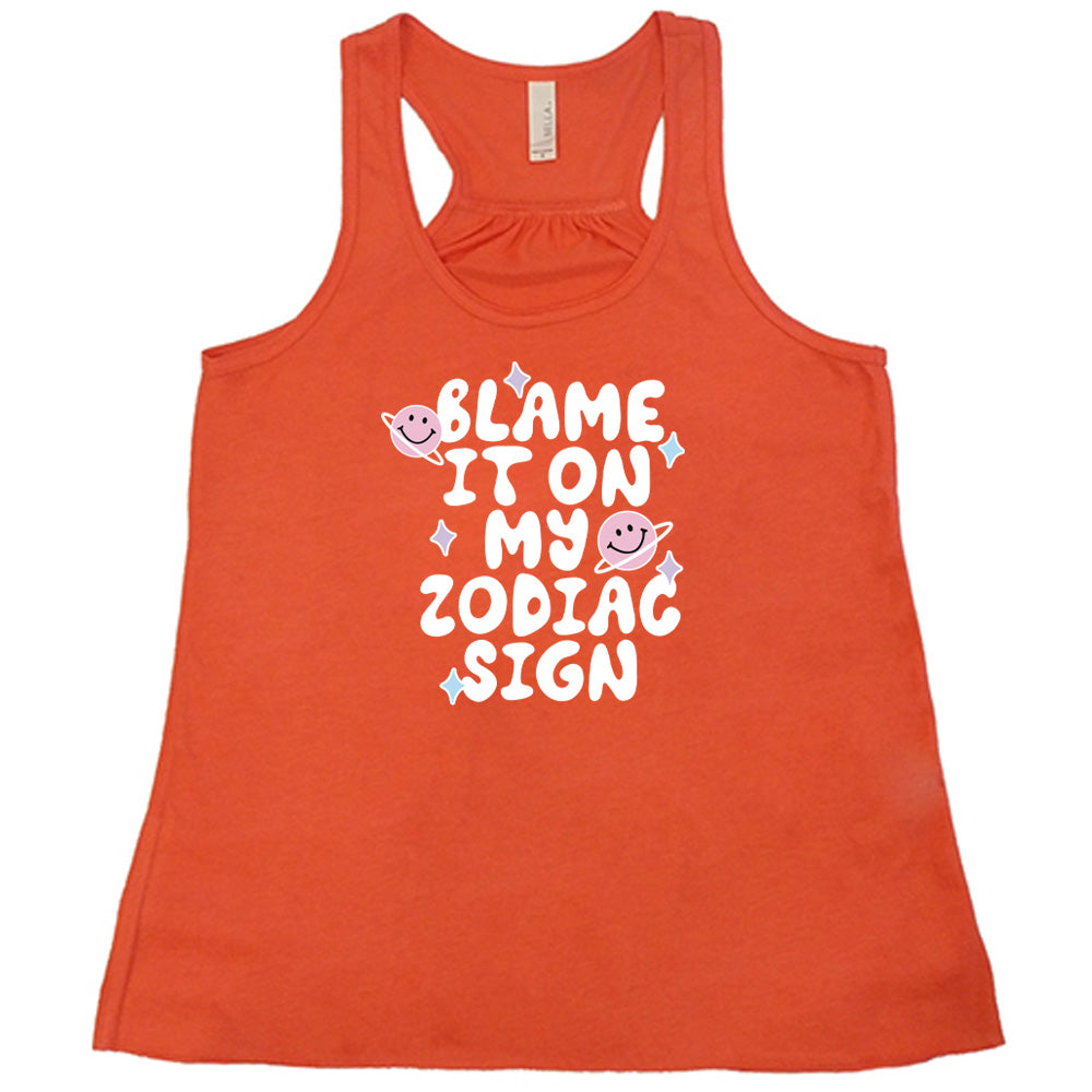 orange shirt with the text "Blame It On My Zodiac Sign" on it