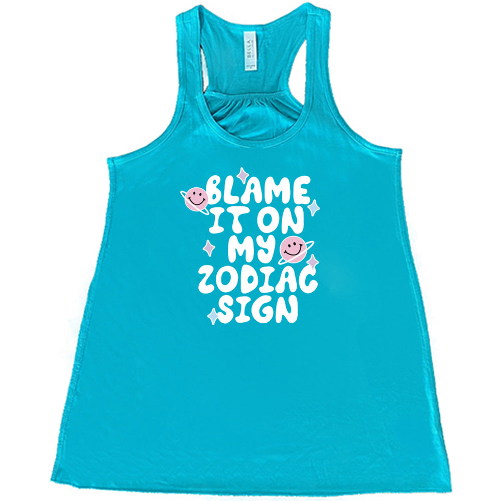 teal shirt with the text "Blame It On My Zodiac Sign" on it