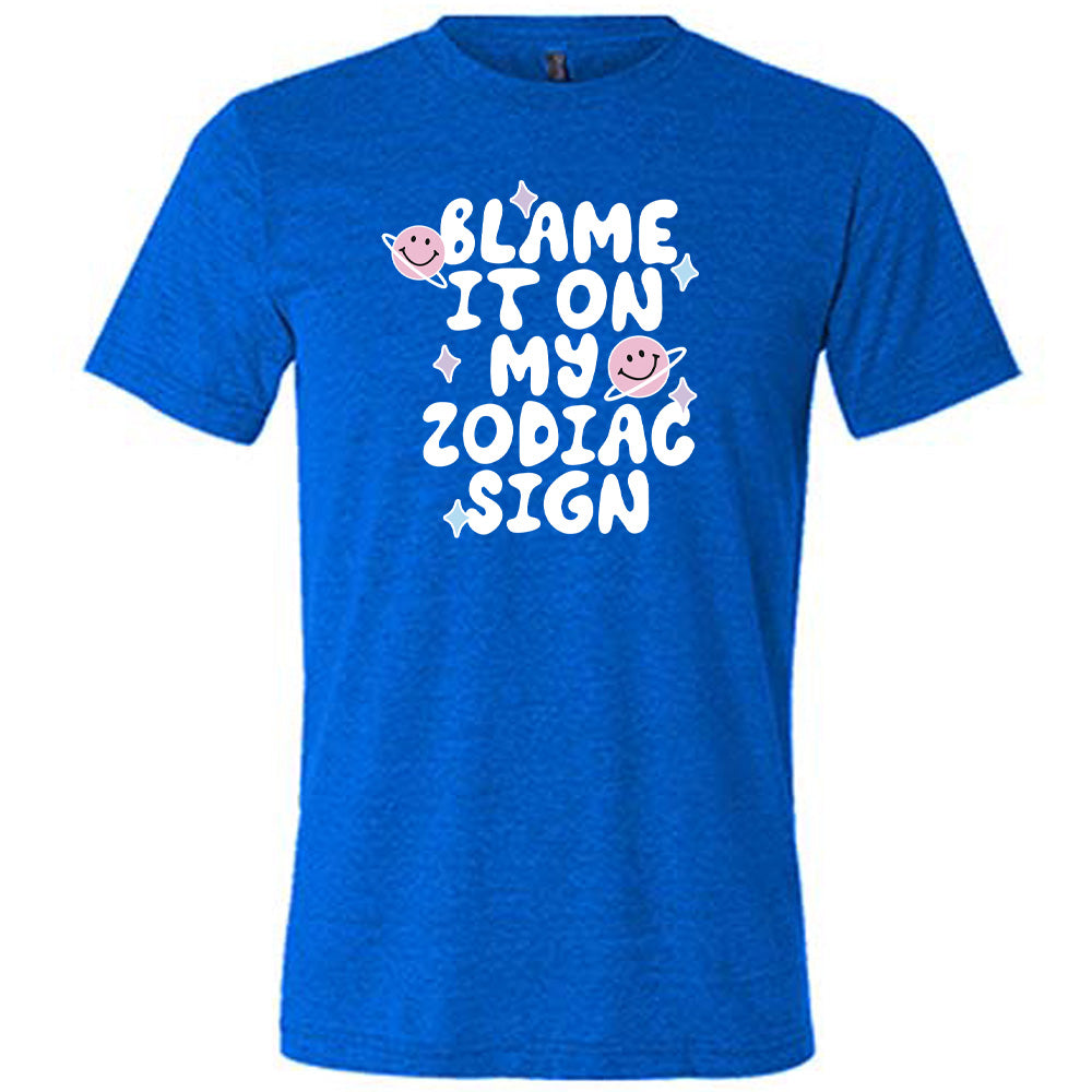 blue shirt with the text "Blame It On My Zodiac Sign" on it