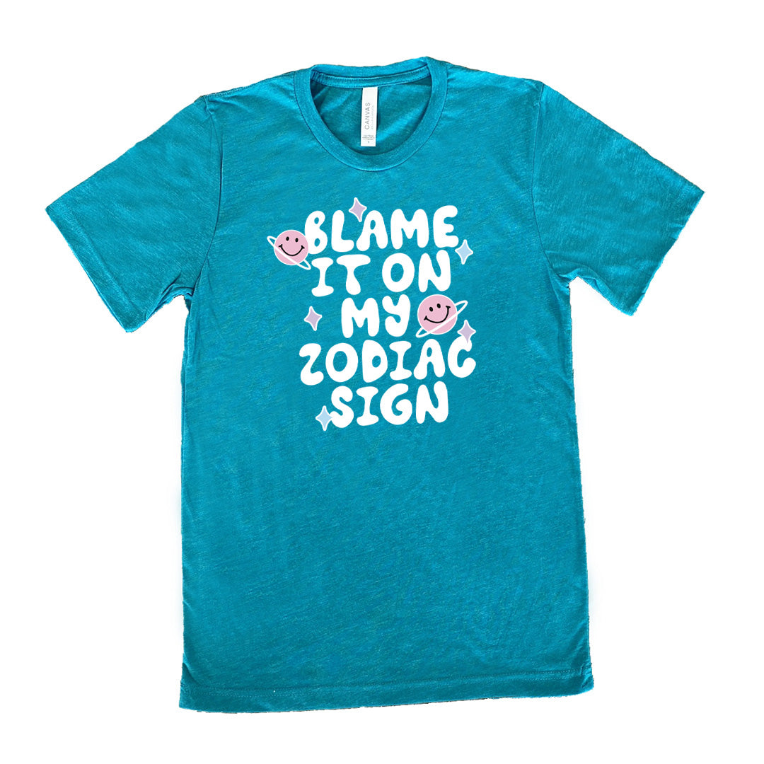 teal shirt with the text "Blame It On My Zodiac Sign" on it