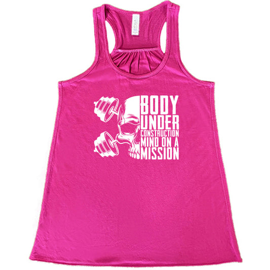 berry shirt with the text "Body Under Construction, Mind on a Mission" on it