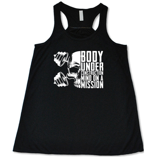 black shirt with the text "Body Under Construction, Mind on a Mission" on it