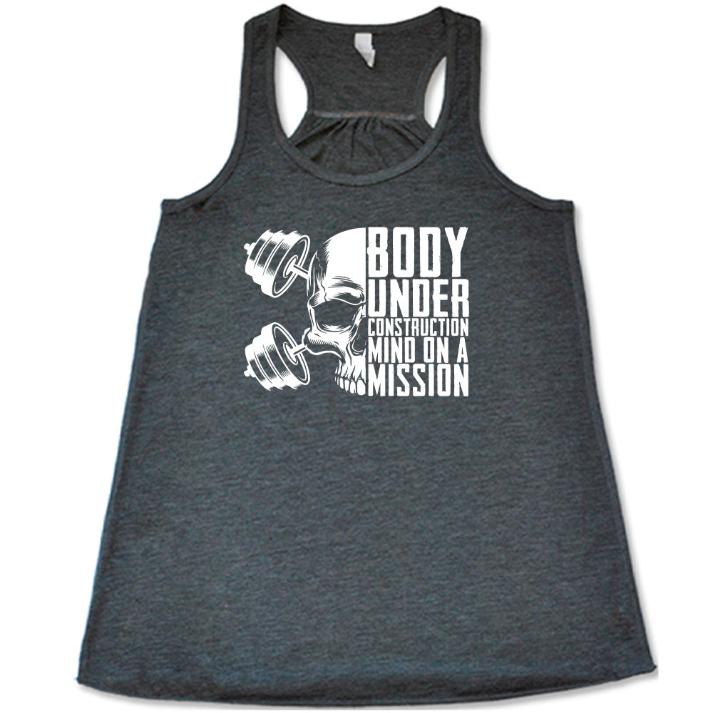 grey shirt with the text "Body Under Construction, Mind on a Mission" on it