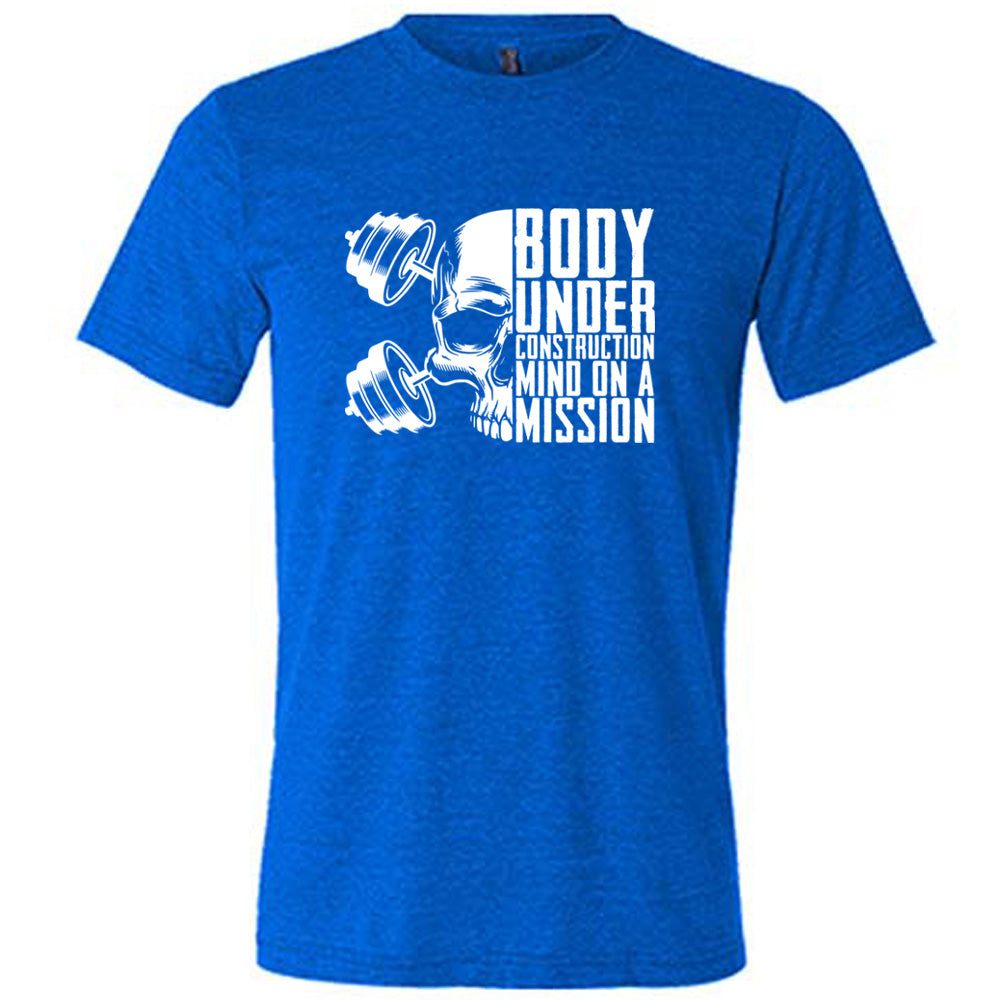 blue shirt with the text "Body Under Construction, Mind on a Mission" on it