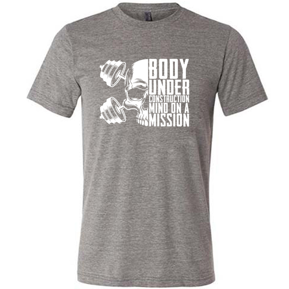 grey shirt with the text "Body Under Construction, Mind on a Mission" on it