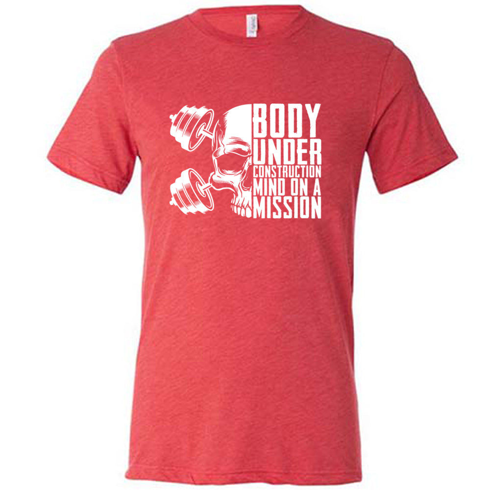 red shirt with the text "Body Under Construction, Mind on a Mission" on it