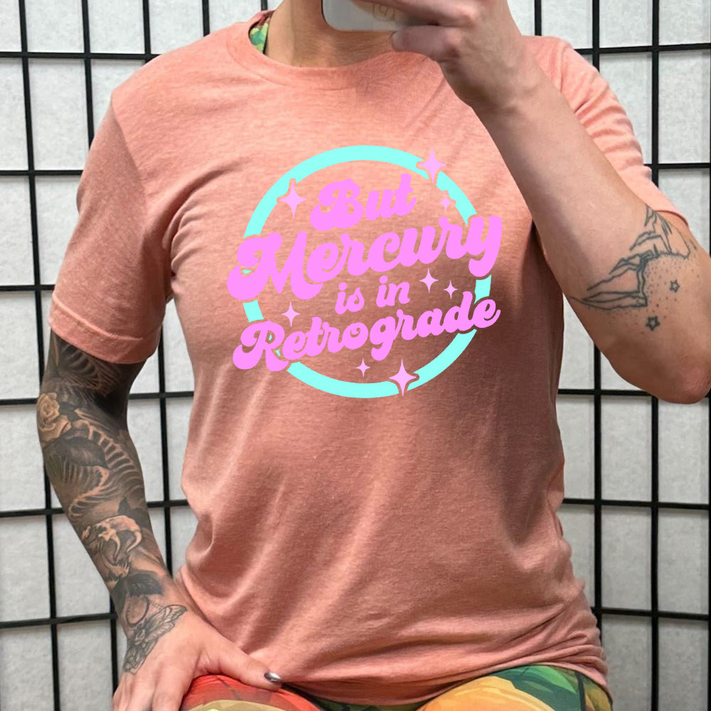 coral shirt with the text "But Mercury Is In Retrograde" on it