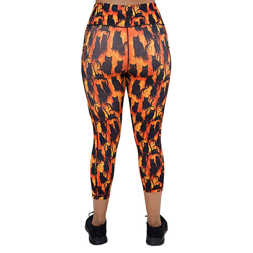 back of the capri length black cats patterned leggings 