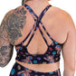 back of the black voodoo doll patterned sports bra