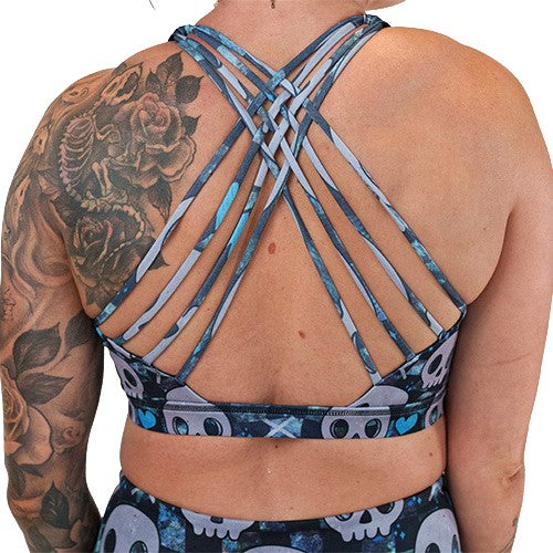 back of the blue hearts and skulls patterned sports bra