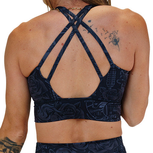 back of the black and grey traditional tattoo design patterned sports bra