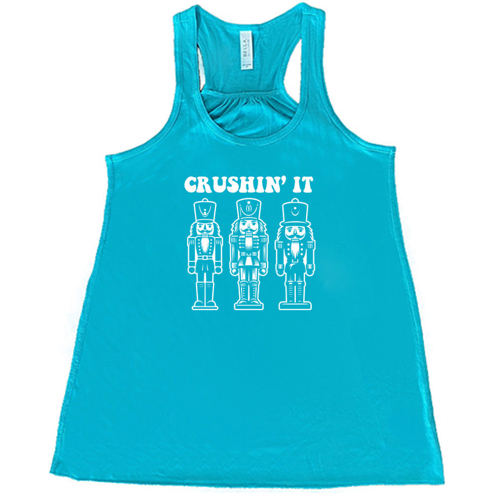 teal shirt with the text "Crushin' It" with nutcracker graphics on it