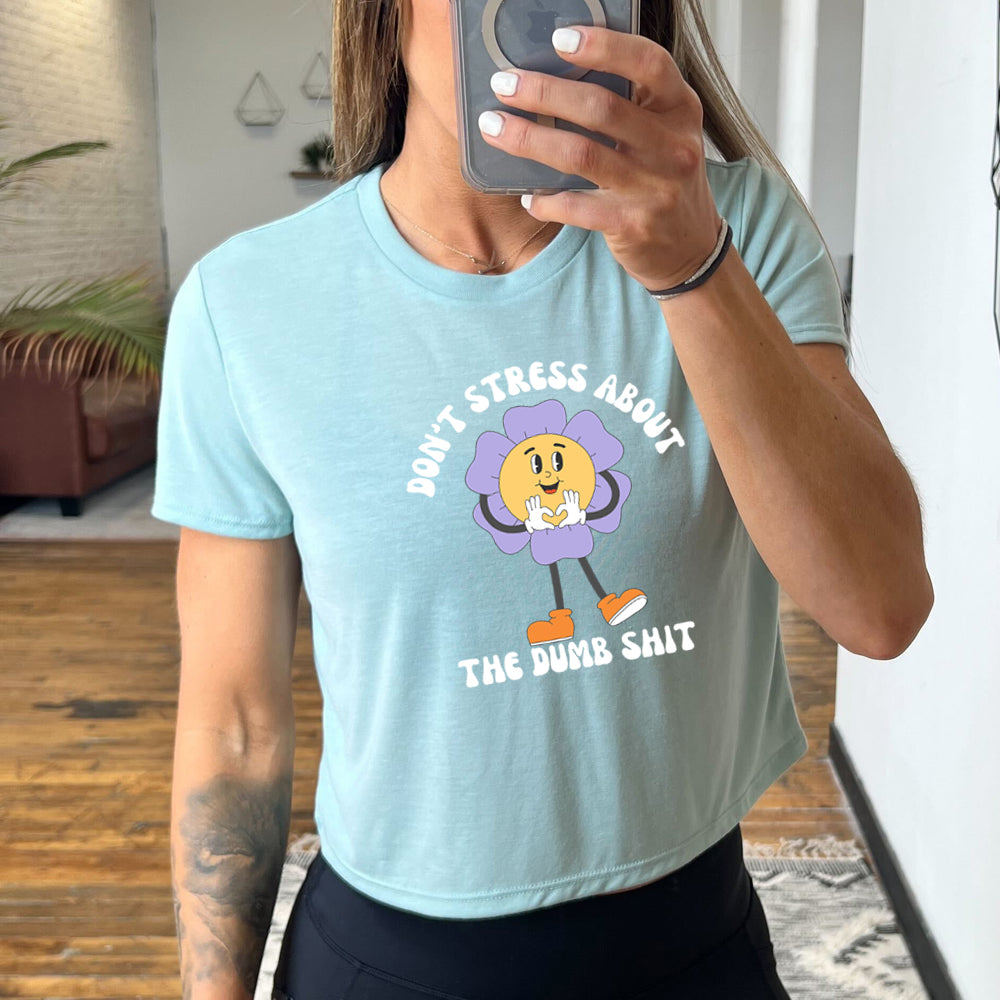 light blue cropped tee with the text "Don't Stress About The Dumb Shit" on it