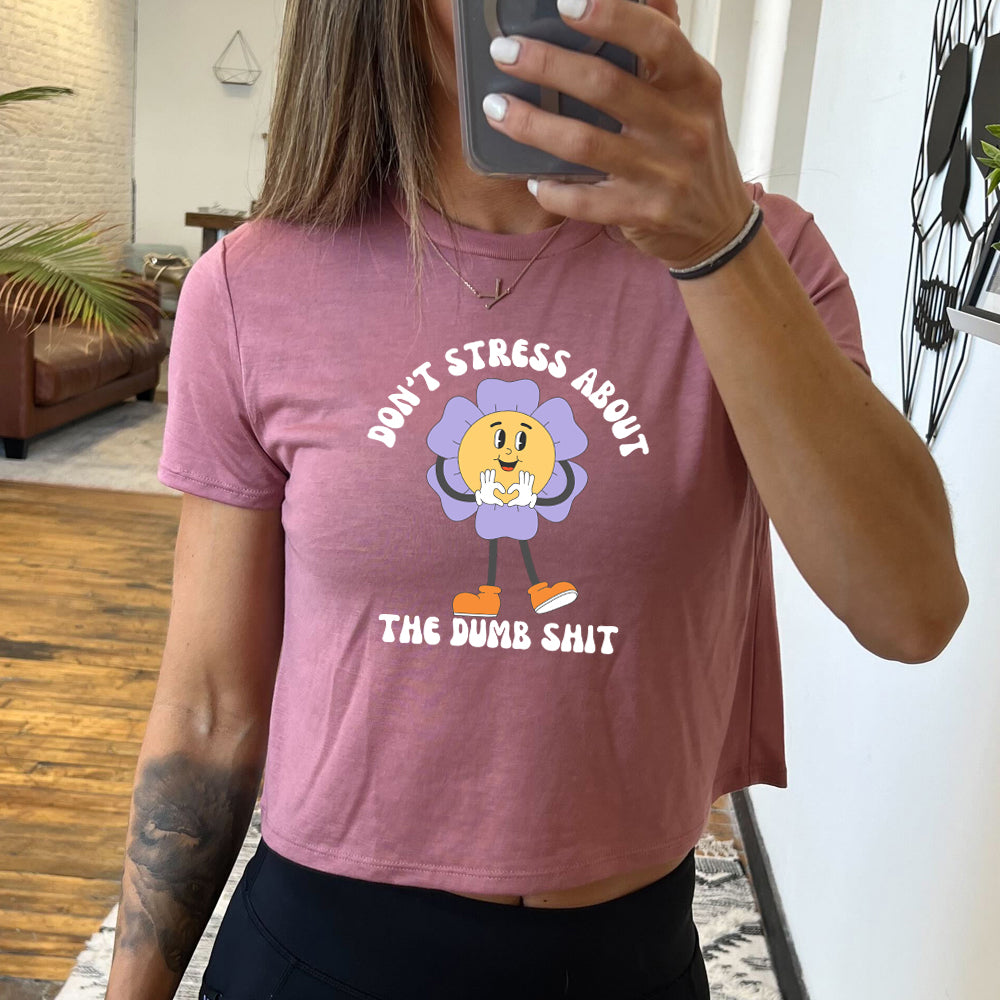 mauve cropped tee with the text "Don't Stress About The Dumb Shit" on it