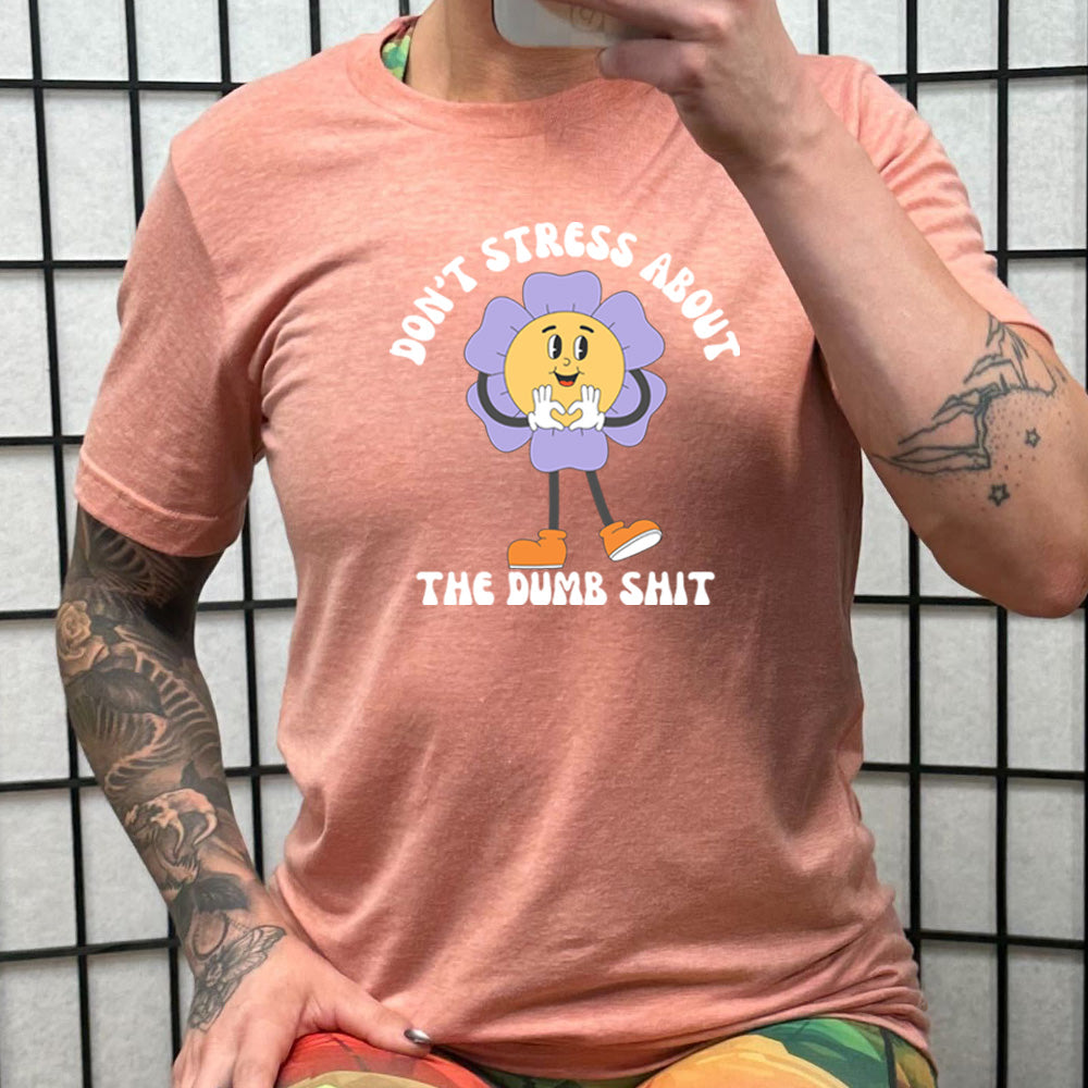 peach shirt with the text "Don't Stress About The Dumb Shit" on it