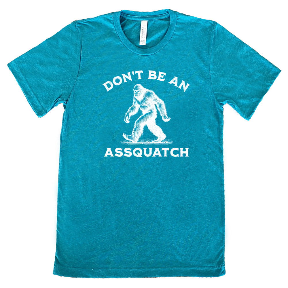 teal shirt with the text "Don't Be An Assquatch" on it