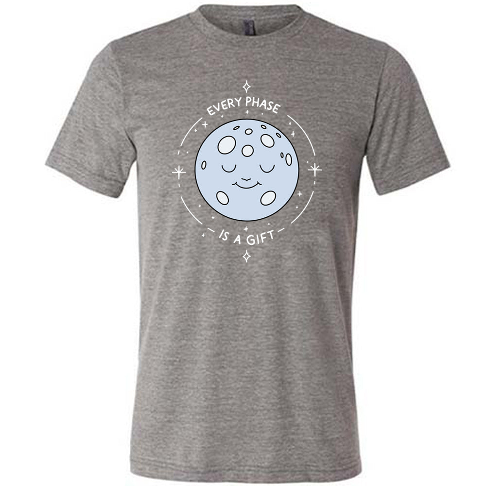 grey shirt with the text "Every Phase Is a Gift" on it