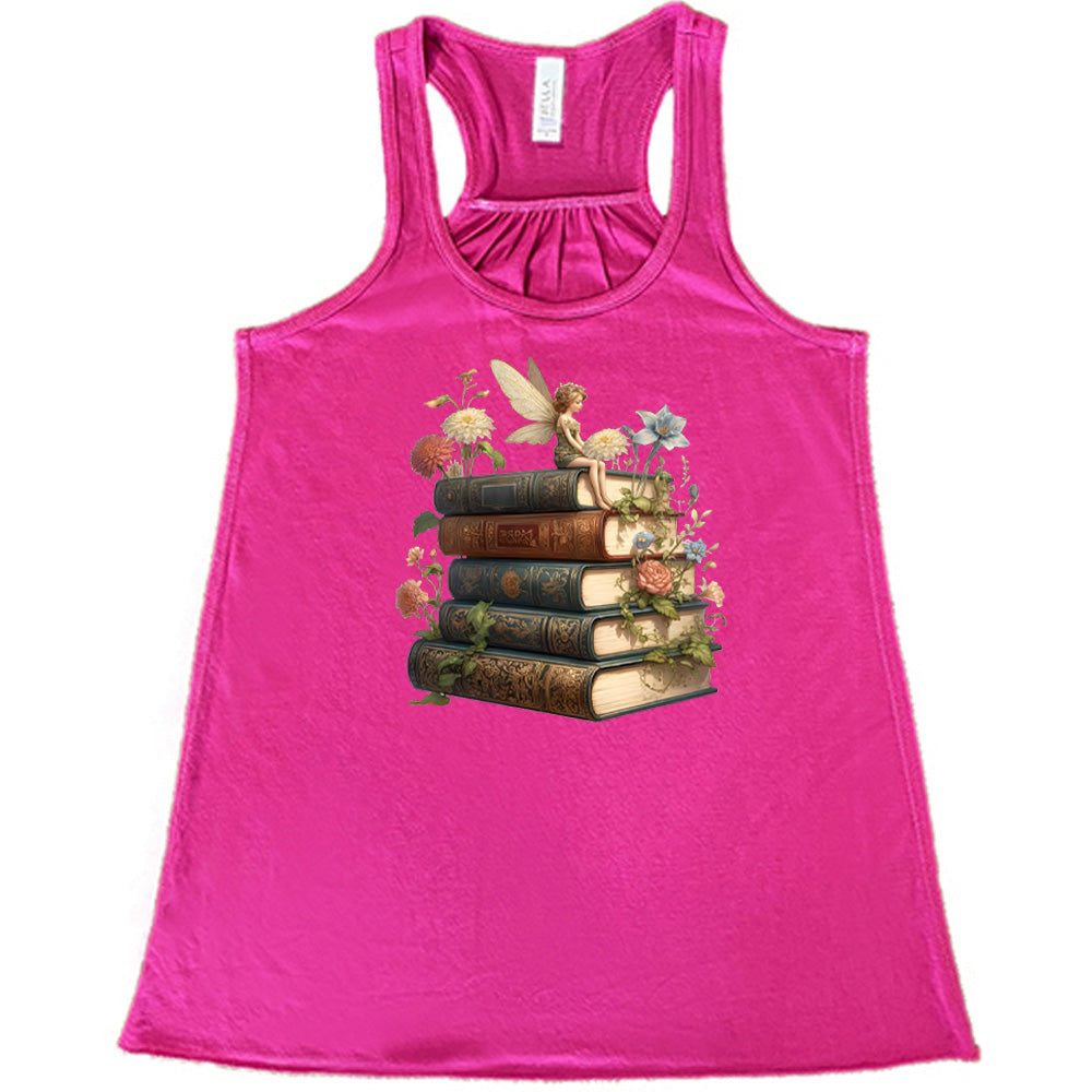 berry shirt with a fairy sitting on books graphic in the center