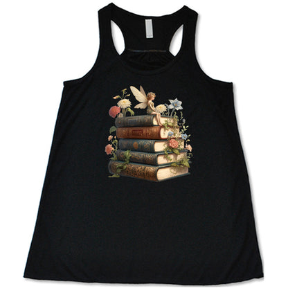 black shirt with a fairy sitting on books graphic in the center