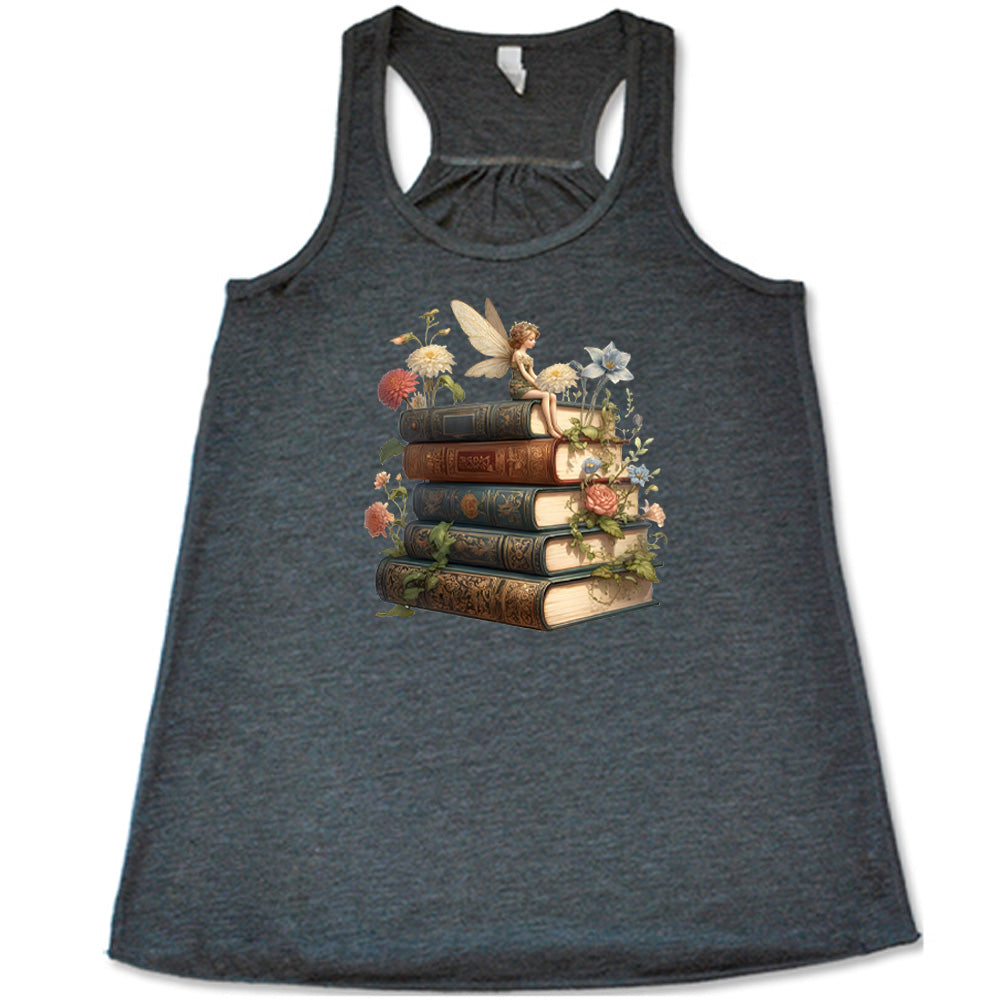 grey shirt with a fairy sitting on books graphic in the center