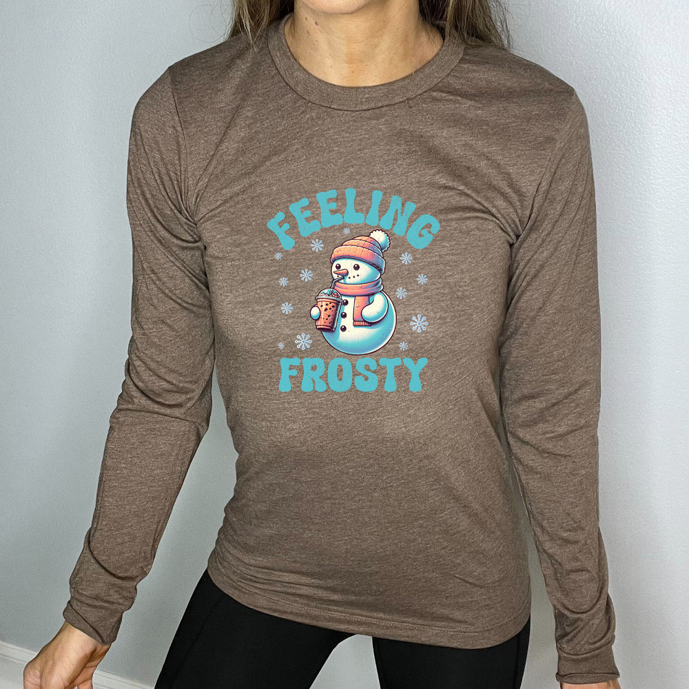 brown long sleeve shirt with the text "Feelin Frosty" and a snowman graphic on it