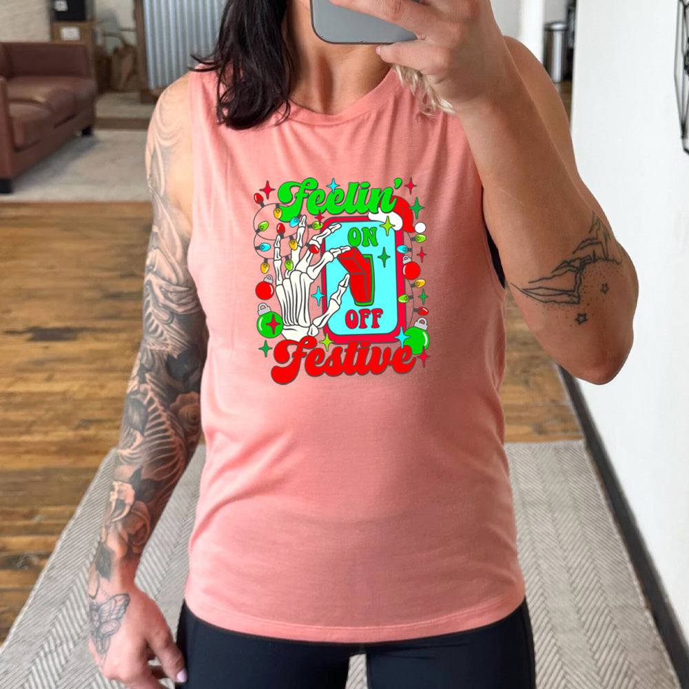 peach muscle tank with the text "Feelin' Festive" on it