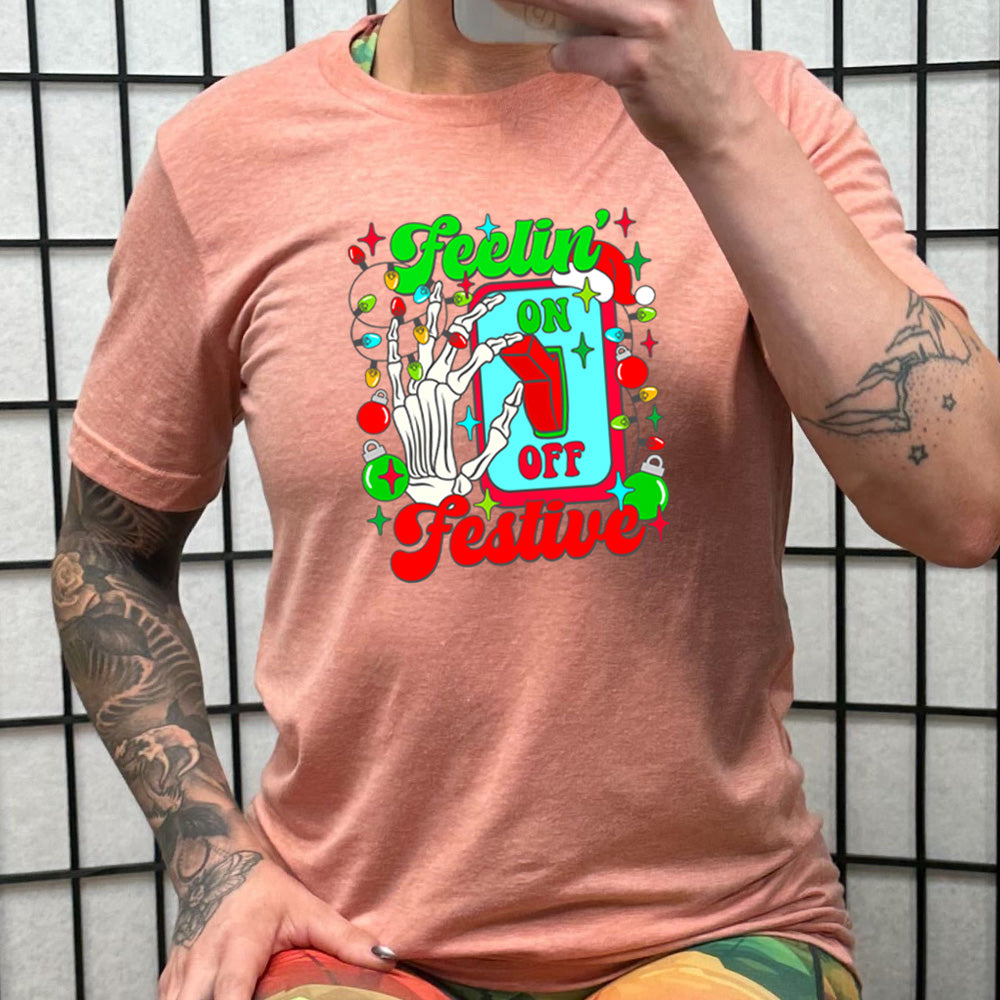 peach shirt with the text "Feelin' Festive" on it