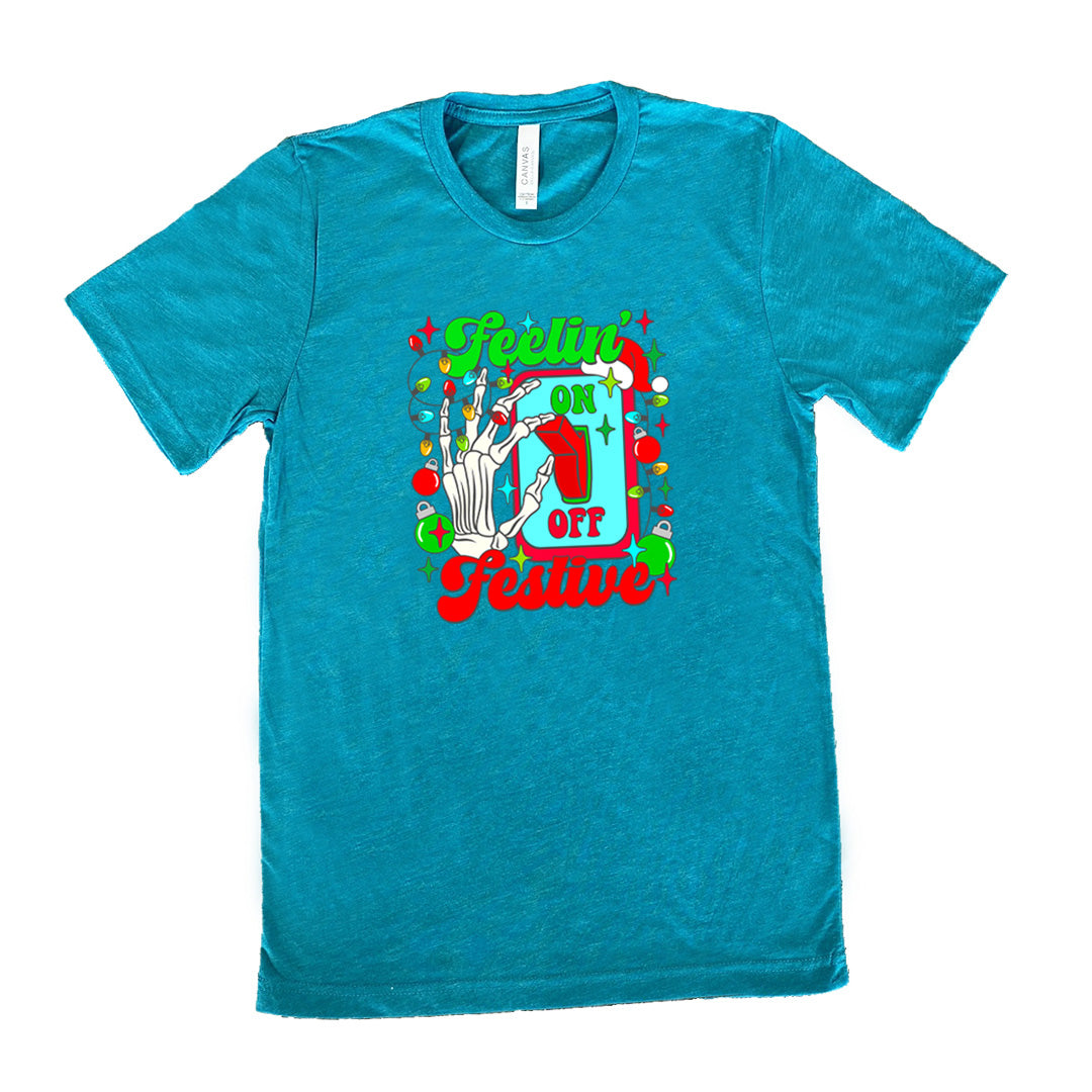 teal shirt with the text "Feelin' Festive" on it