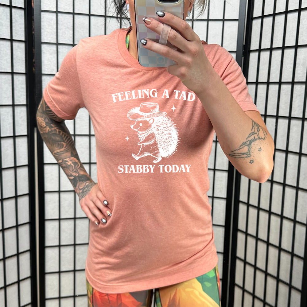 coral shirt with the text "Feeling A Tad Stabby Today" on it