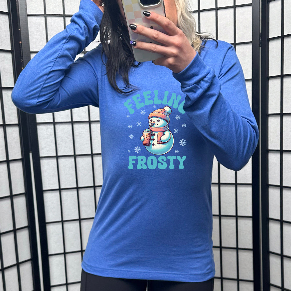 blue long sleeve shirt with the text "Feelin Frosty" and a snowman graphic on it