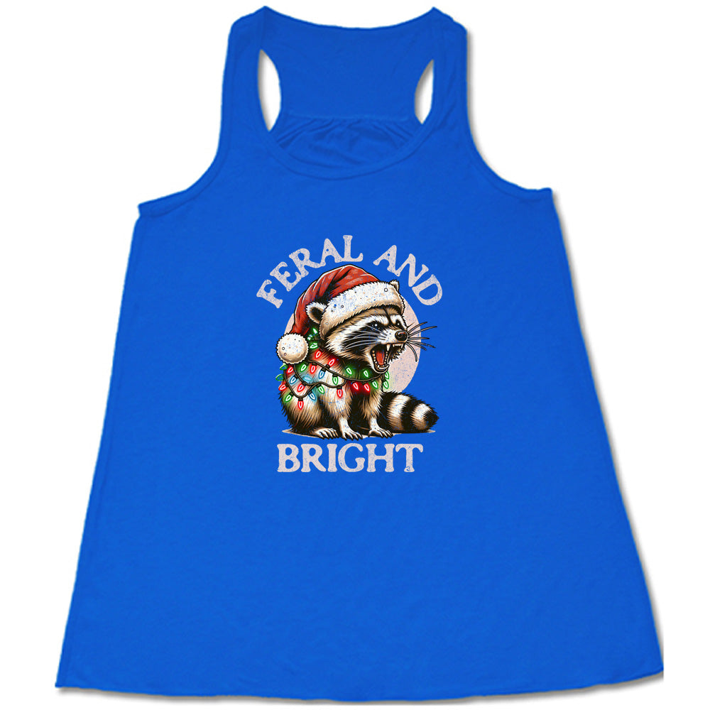 blue shirt with the text "Feral And Bright" with a raccoon graphic on it 