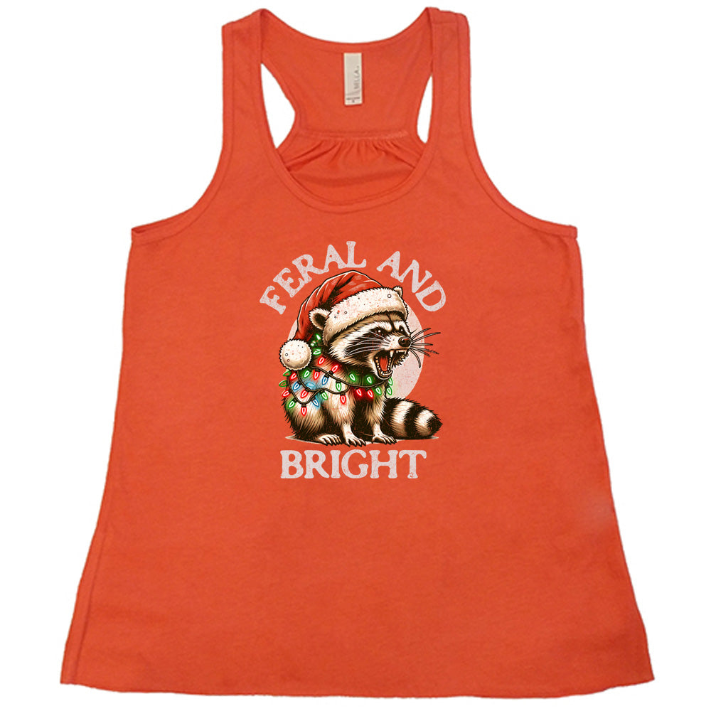 coral shirt with the text "Feral And Bright" with a raccoon graphic on it 