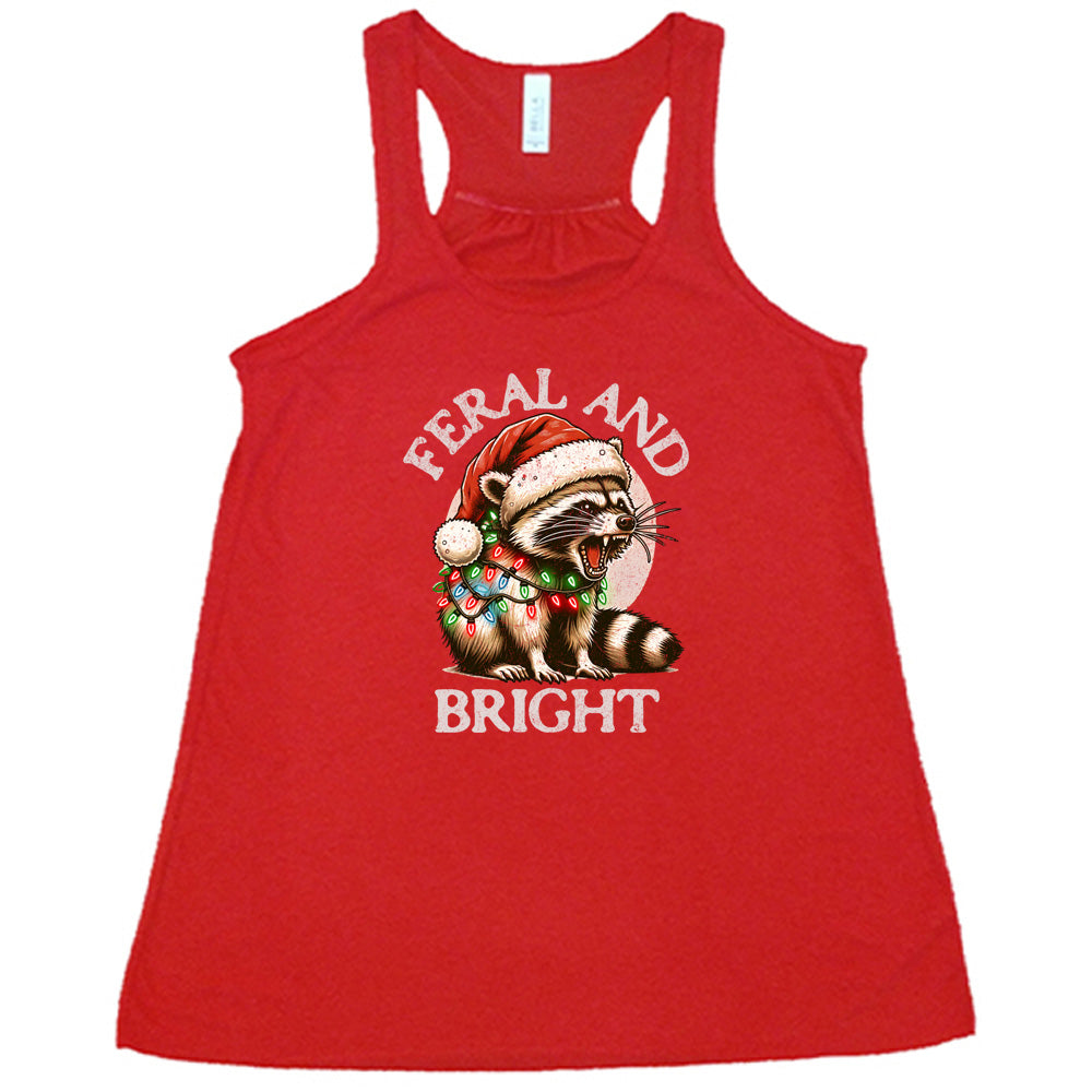 red shirt with the text "Feral And Bright" with a raccoon graphic on it 