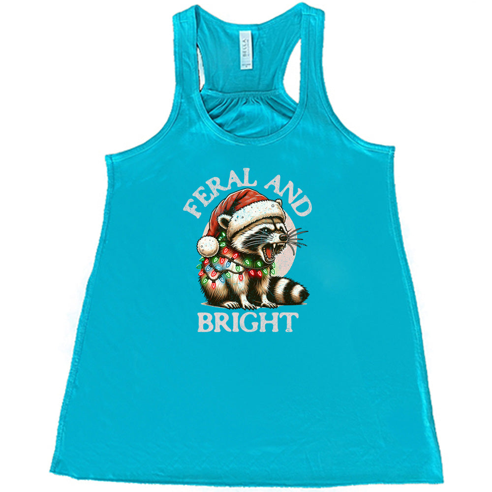 teal shirt with the text "Feral And Bright" with a raccoon graphic on it 