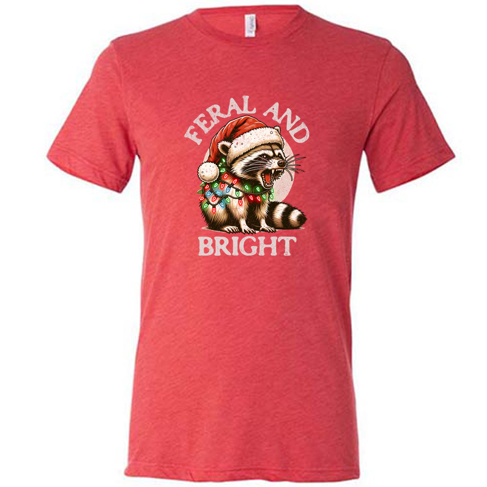 red shirt with the text "Feral And Bright" with a raccoon graphic on it