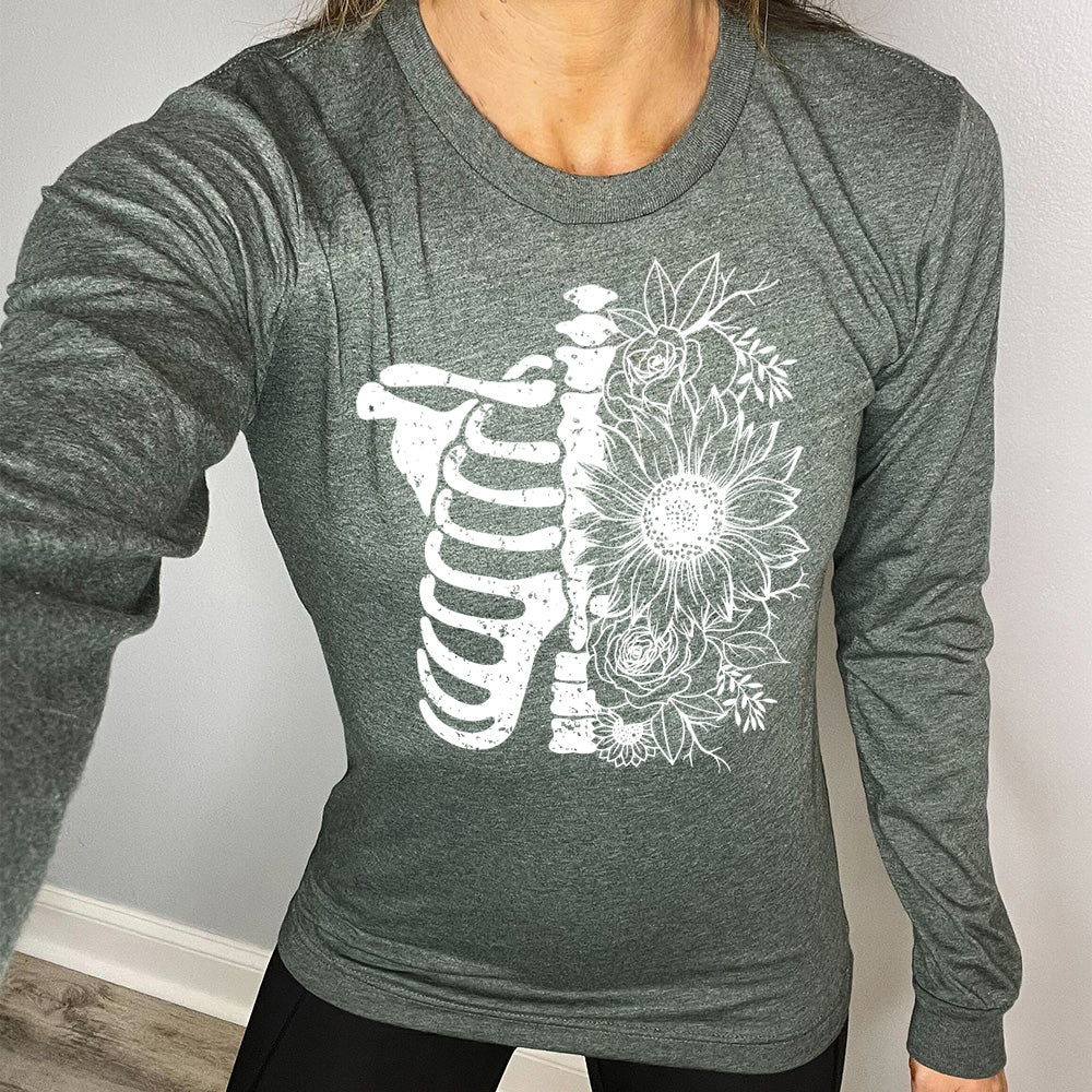 forest green long sleeve shirt with a white Floral Ribcage graphic on it