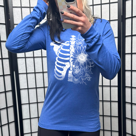 blue long sleeve shirt with a white Floral Ribcage graphic on it