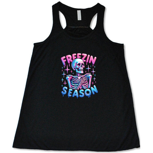 black shirt with the text "freezin season" with a graphic of a skeleton on it