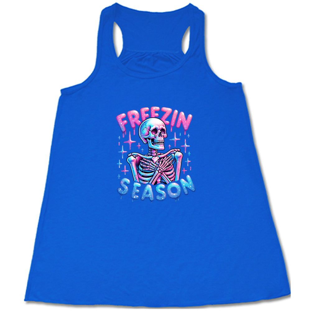 blue shirt with the text "freezin season" with a graphic of a skeleton on it