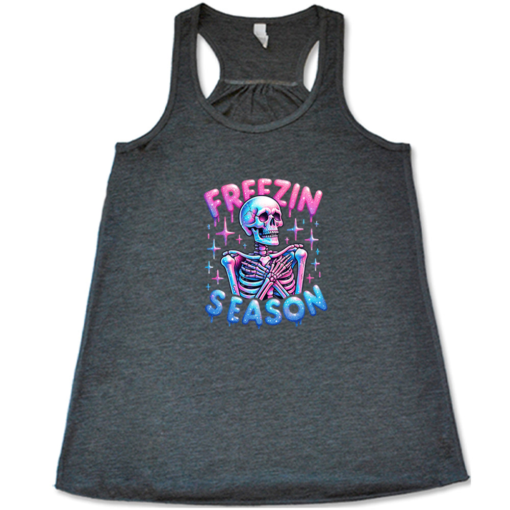 grey shirt with the text "freezin season" with a graphic of a skeleton on it