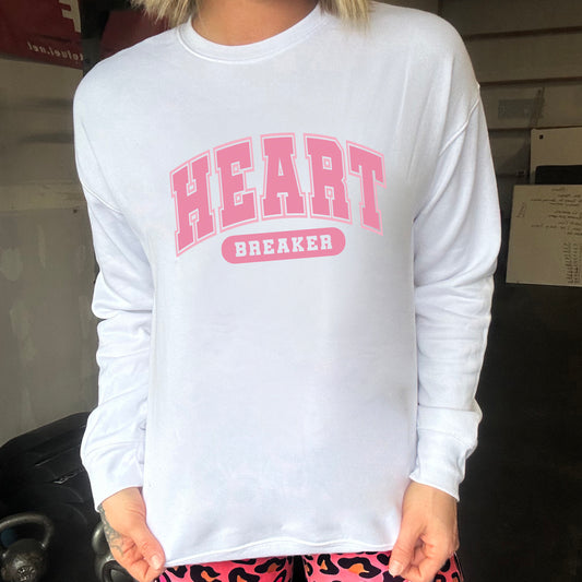 white crewneck with the text "Heart Breaker" on it in pink