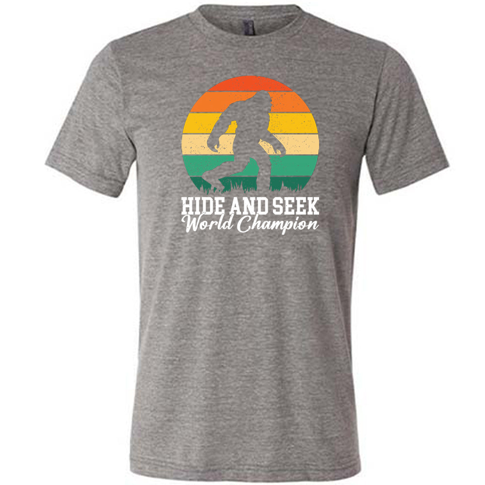 grey shirt with the text "Hide And Seek World Champion" on it